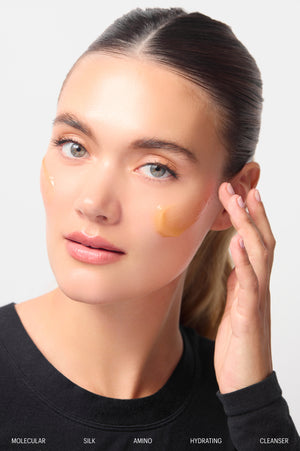 Model with Molecular Silk Amino Hydrating Cleanser on her cheek