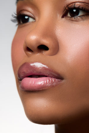 Close-up of glossy lips wearing Peptint Lip Treatment