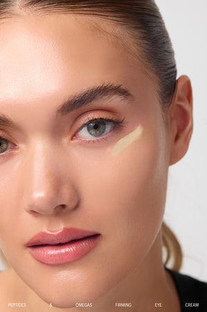 Model with eye cream swatch applied under the eye