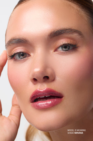 Model wearing Peptint shade Nirvana, a warm pink lip tint