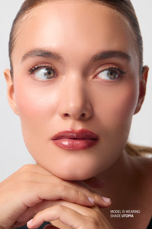 Close-up portrait of model wearing Peptint in shade Utopia